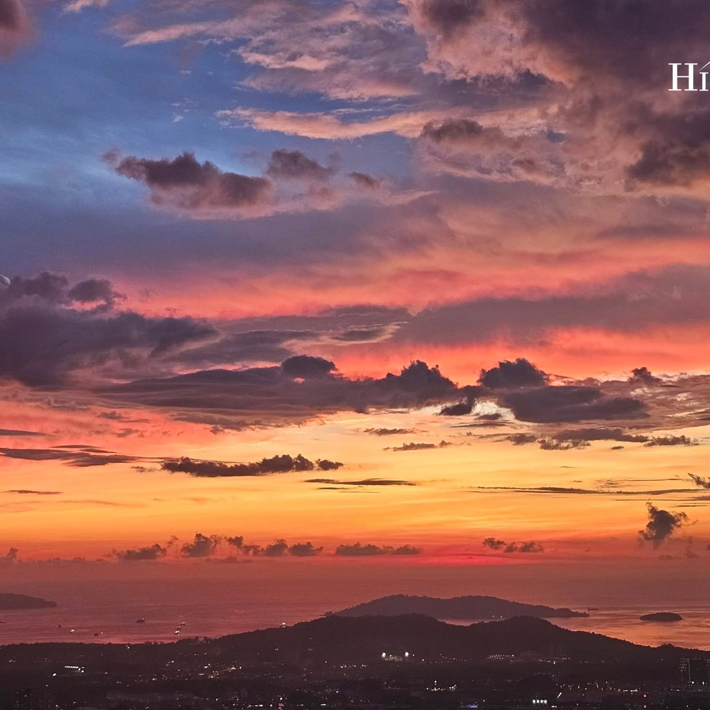 Fire and violet clouds over Kota Kinabalu at dusk, seen from Hillside Kokol on Kokol Hill